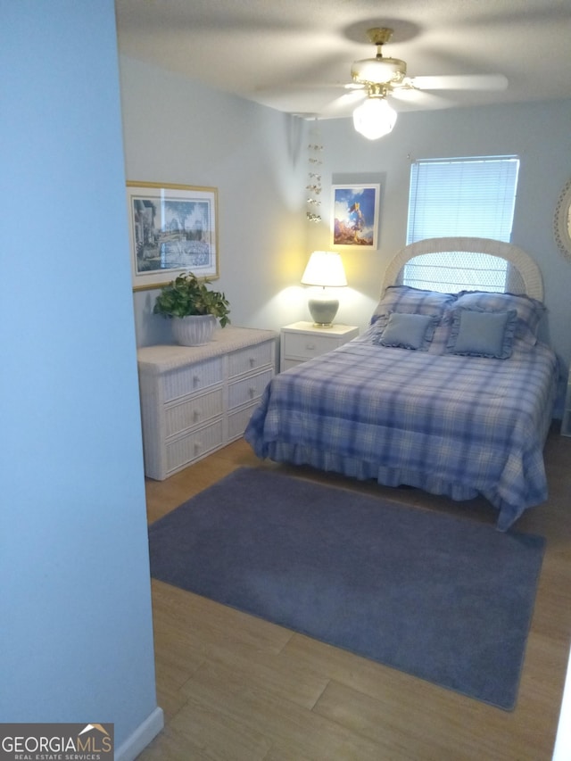 bedroom featuring light wood-type flooring and ceiling fan