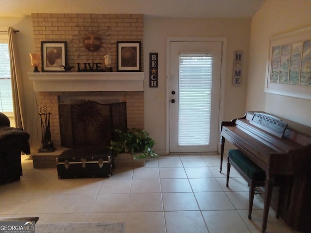 interior space featuring a fireplace, a wealth of natural light, and light tile patterned floors