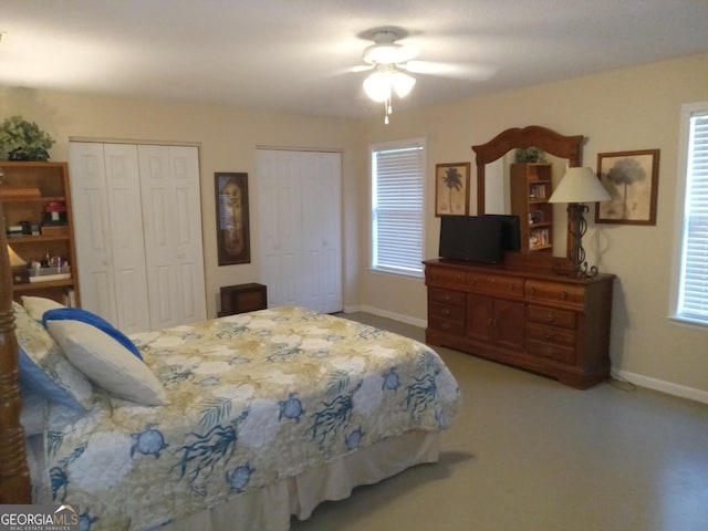 bedroom with multiple closets and ceiling fan