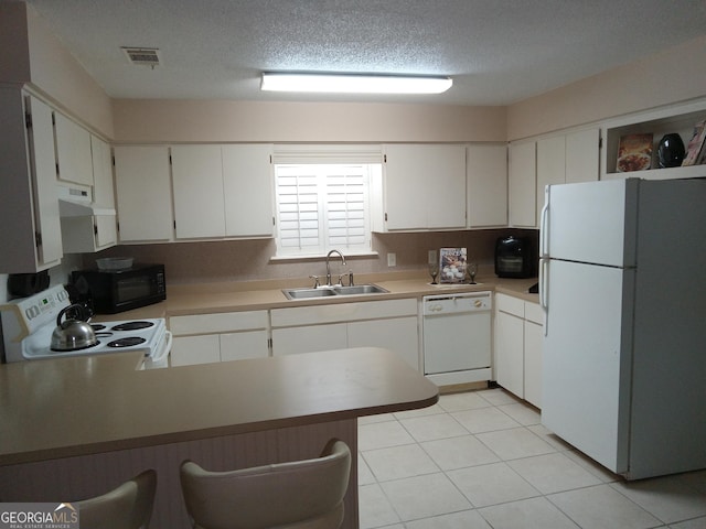 kitchen featuring white appliances, white cabinetry, extractor fan, and sink