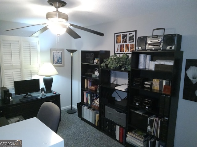 carpeted office featuring ceiling fan