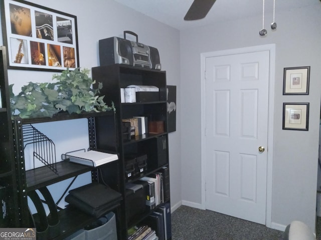 carpeted office space featuring ceiling fan