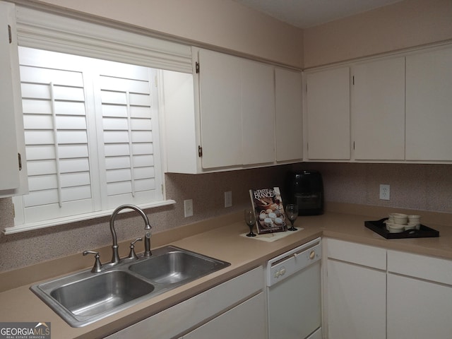 kitchen featuring white cabinets, dishwasher, backsplash, and sink