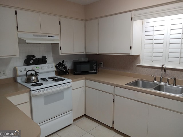 kitchen featuring light tile patterned floors, tasteful backsplash, electric range, white cabinets, and sink