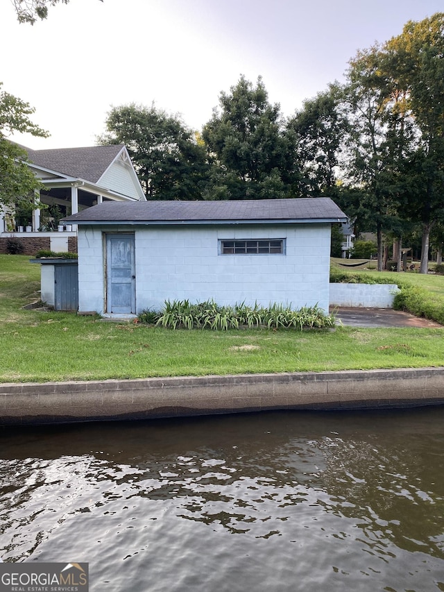 exterior space with a lawn and a water view