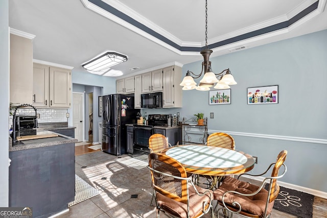 tiled dining area featuring a chandelier, crown molding, and sink