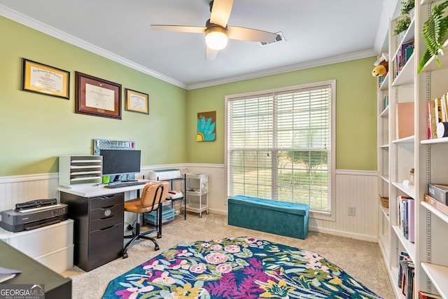 home office featuring light carpet, ceiling fan, and ornamental molding