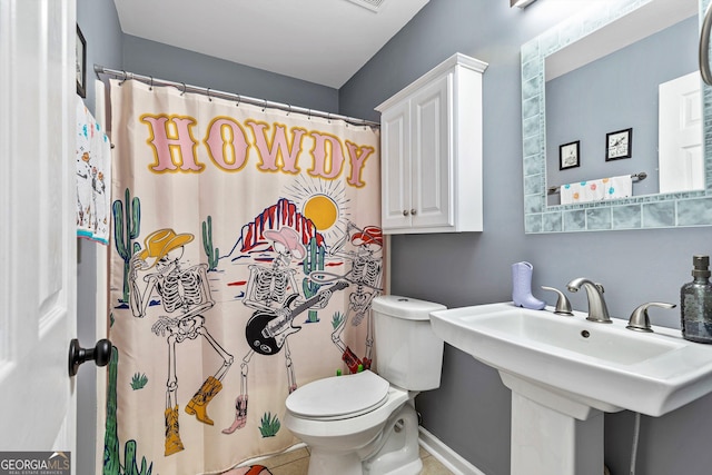 bathroom with tile patterned flooring, a shower with curtain, toilet, and sink