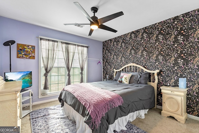 bedroom featuring multiple windows, light carpet, and ceiling fan