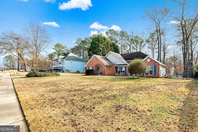 ranch-style home with a front lawn