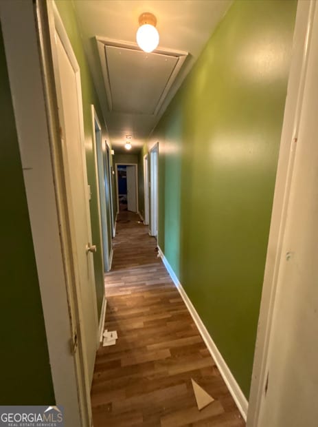 hallway with dark hardwood / wood-style flooring