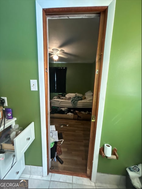 interior space with tile patterned flooring and ceiling fan