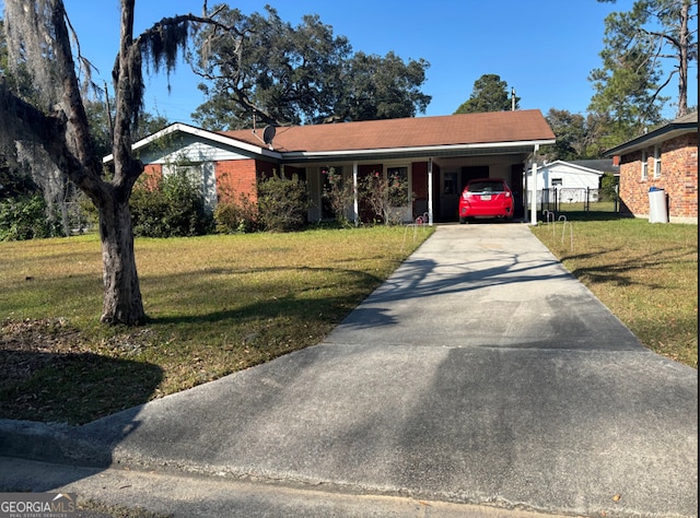 view of front of home with a front yard and a carport