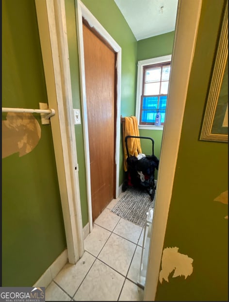 corridor with light tile patterned floors