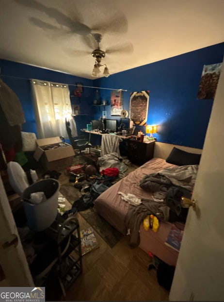 bedroom with ceiling fan and wood-type flooring