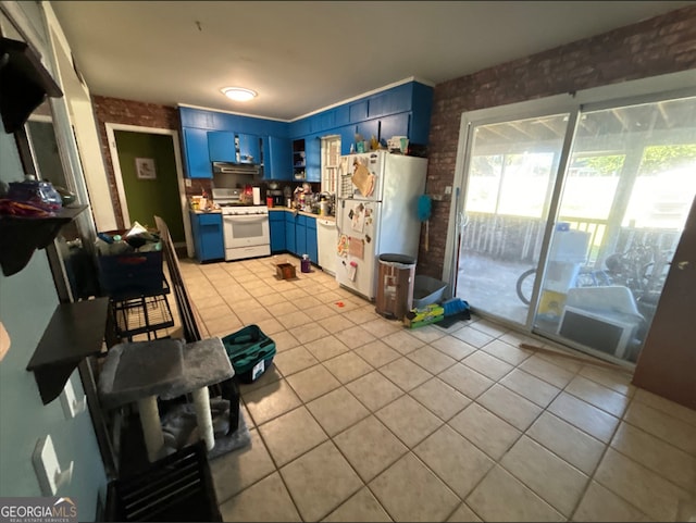 kitchen featuring light tile patterned floors, white appliances, blue cabinets, and brick wall