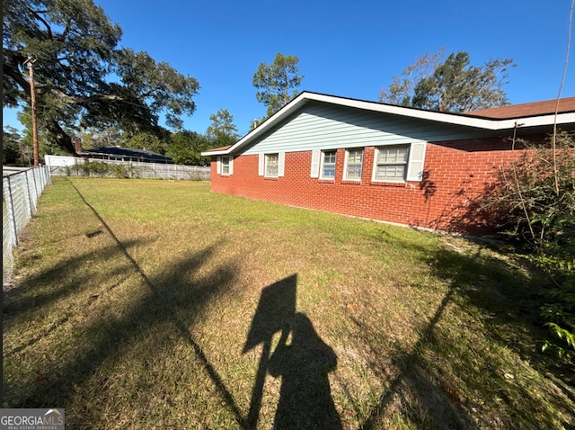 view of side of property featuring a yard