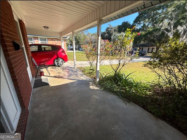 view of vehicle parking with a lawn