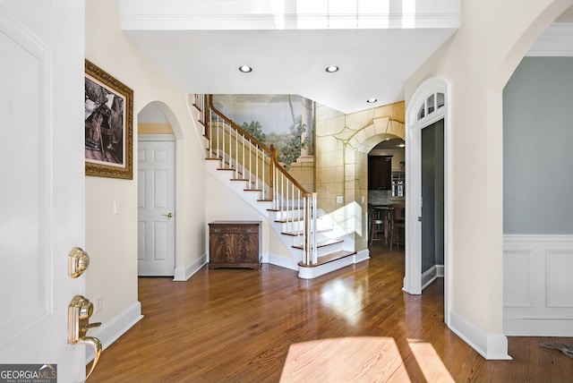 entryway featuring hardwood / wood-style flooring and ornamental molding