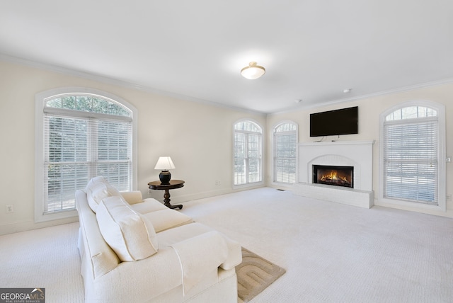 carpeted living room featuring a fireplace and crown molding