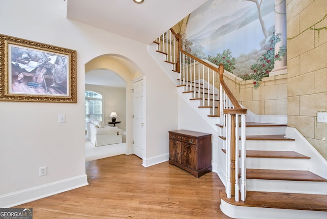 stairs featuring wood-type flooring