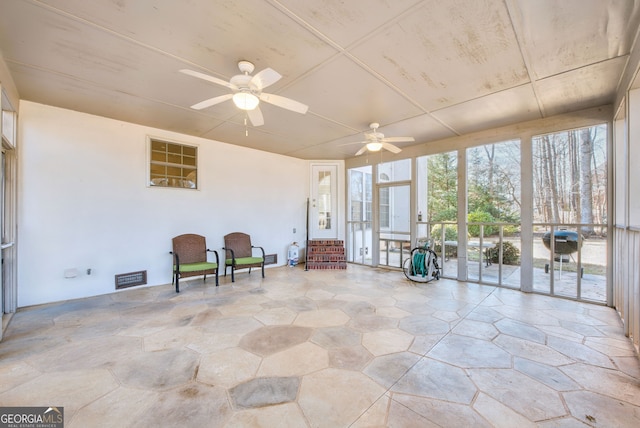 sunroom featuring ceiling fan