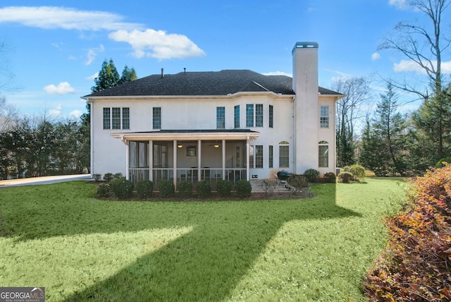 back of house featuring a sunroom and a yard