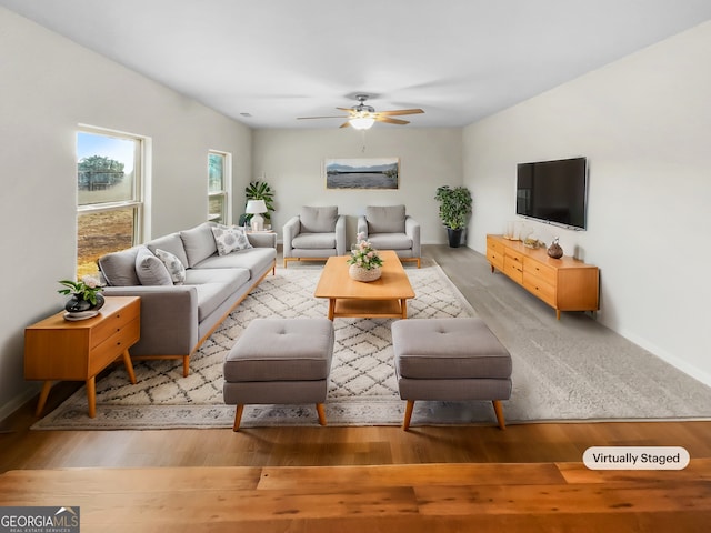 living room with hardwood / wood-style floors and ceiling fan