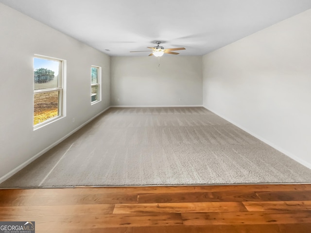 carpeted empty room featuring ceiling fan