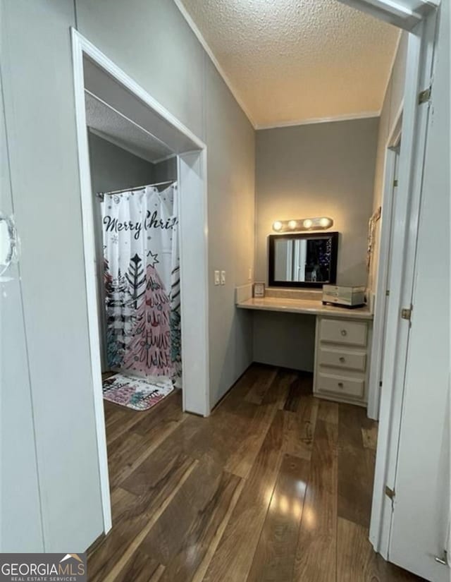 bathroom with hardwood / wood-style flooring, vanity, a shower with curtain, and a textured ceiling