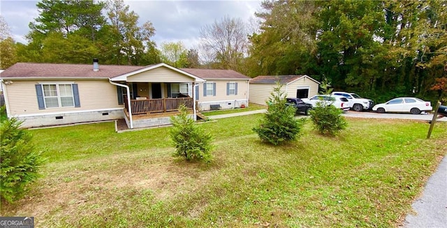 view of front of house with covered porch, a shed, and a front lawn