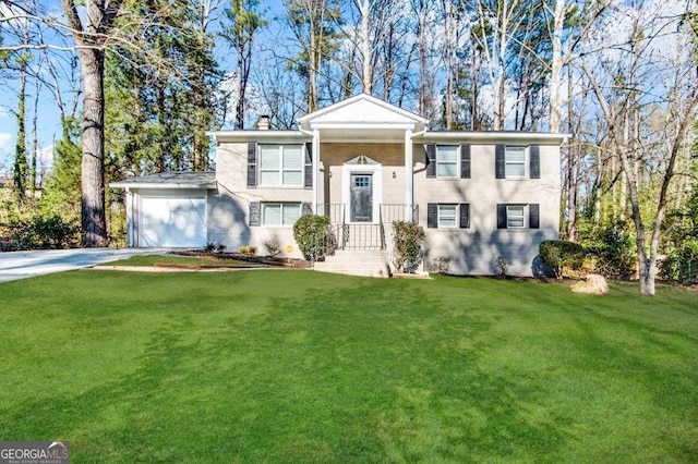 view of front of home with a garage and a front yard