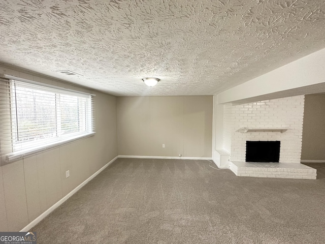 unfurnished living room featuring carpet flooring, a fireplace, and a textured ceiling