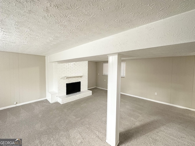 basement with a fireplace, a textured ceiling, and carpet floors