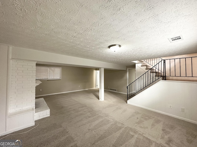 basement featuring carpet and a textured ceiling