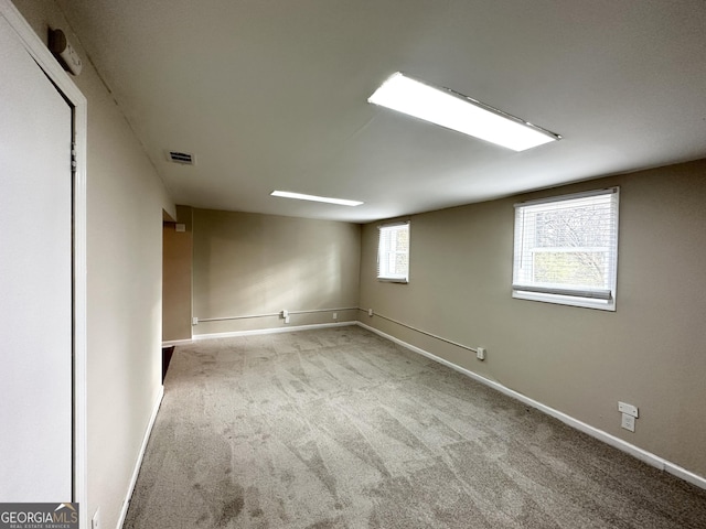 basement featuring light carpet