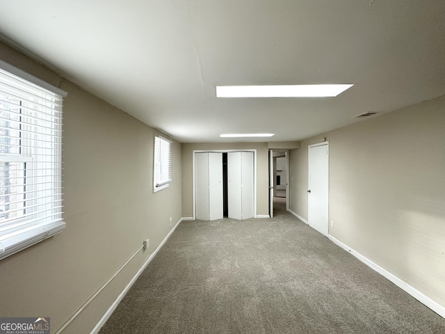 unfurnished bedroom featuring carpet and multiple closets