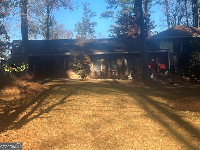 rear view of property featuring a yard