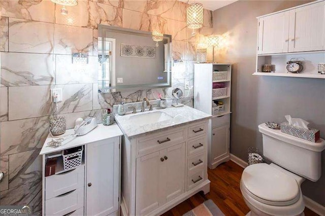 bathroom with vanity, hardwood / wood-style flooring, and toilet