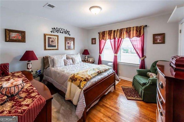 bedroom with wood-type flooring