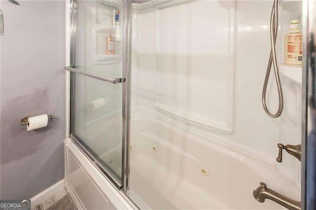 bathroom with shower / bath combination with glass door