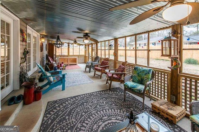 sunroom / solarium featuring ceiling fan