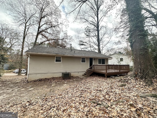 rear view of house with central AC and a deck