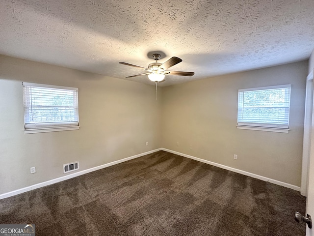 spare room with carpet flooring, ceiling fan, and a textured ceiling