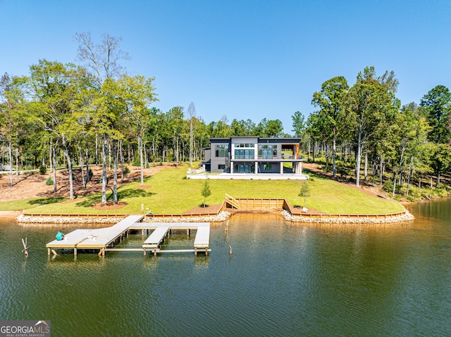 back of property with a lawn and a water view