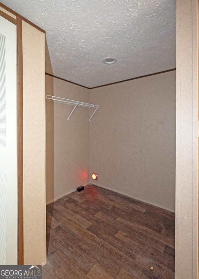 laundry area featuring hardwood / wood-style floors and a textured ceiling