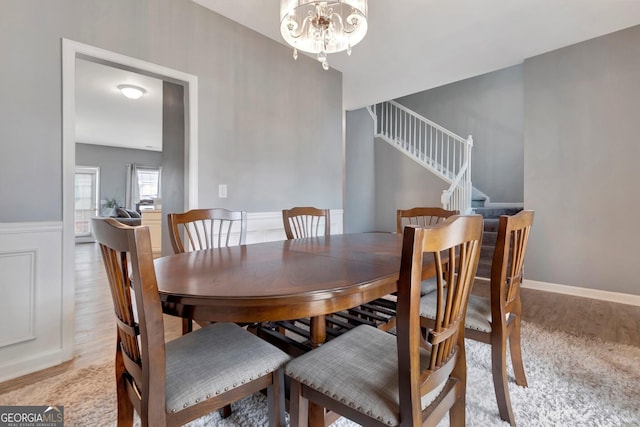 dining room featuring light hardwood / wood-style flooring and a notable chandelier