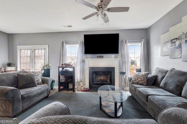 living room featuring ceiling fan and plenty of natural light