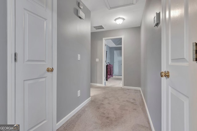 hall featuring light colored carpet