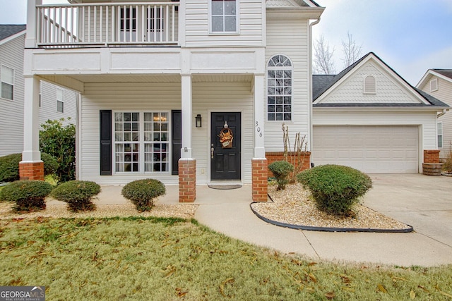 view of front facade featuring a balcony and a garage